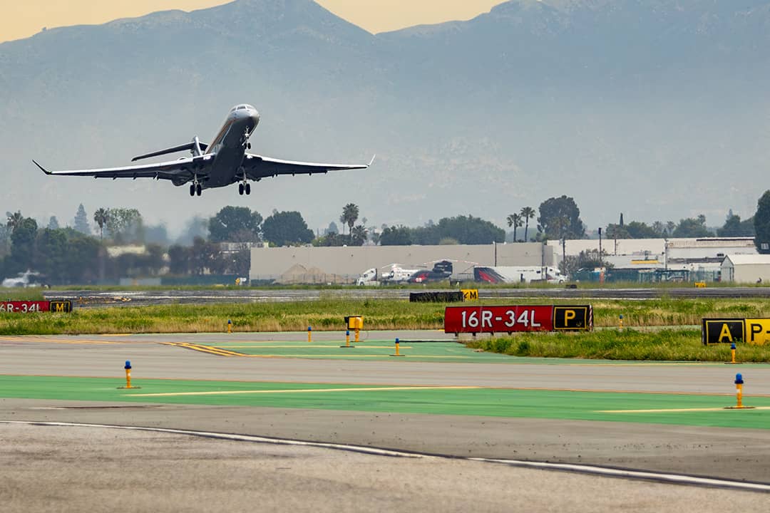 A Global 7500, built by Bombardier is seen climbing out of runway 16R on an afternoon departure from California.